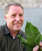Photo of Tim Miller holding dock weed leaves