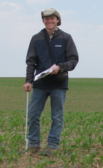 Ryan Solemslie holding a clipboard and soil probe